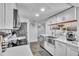 Bright kitchen featuring modern appliances, white cabinetry, and a stylish stainless steel sink at 758 Orchid Dr, Davenport, FL 33897