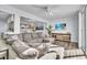 Bright and airy living room featuring a large sectional sofa, modern furnishings, and wood-look flooring at 758 Orchid Dr, Davenport, FL 33897