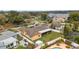 Wide aerial shot showing neighborhood, community lake, home with solar panels and pool at 8128 Hook Cir, Orlando, FL 32836