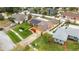 This aerial showcases a single-Gathering house featuring solar panels, a fenced yard, and lovely landscaping at 8128 Hook Cir, Orlando, FL 32836