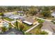 An aerial view of a single story home with a screened in patio, solar panels, fenced yard and an in-ground pool at 8128 Hook Cir, Orlando, FL 32836