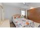 Bright bedroom featuring a floral-patterned comforter, neutral walls, and closet at 8128 Hook Cir, Orlando, FL 32836