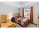 Well-lit bedroom with a desk, chair, and warm-toned decor for a functional space at 8128 Hook Cir, Orlando, FL 32836