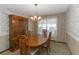 Formal dining room with a wooden table and chairs, chandelier, and a vintage hutch at 8128 Hook Cir, Orlando, FL 32836