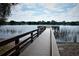 Beautiful lake view from the wooden community dock, ideal for serene walks and waterfront enjoyment at 8128 Hook Cir, Orlando, FL 32836