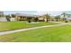 Lush front lawn featuring mature palm trees, solar panels, and a well-manicured landscape at 8128 Hook Cir, Orlando, FL 32836