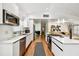 Bright modern kitchen with white cabinets, stainless steel appliances, and wood flooring at 8128 Hook Cir, Orlando, FL 32836