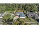 Aerial view of a charming home featuring fresh landscaping, an inviting driveway, and a gray roof at 8691 Contoura Dr, Orlando, FL 32810