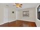 Sunlit bedroom featuring hardwood floors, ceiling fan, and closet for storage at 8691 Contoura Dr, Orlando, FL 32810