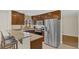 Modern kitchen boasts stainless steel refrigerator and bar-style granite counter at 8691 Contoura Dr, Orlando, FL 32810