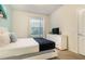 Bedroom featuring a bed with a white headboard, a dresser with a TV, and a window with blinds at 8912 Adriatico Ln, Kissimmee, FL 34747