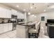 Modern kitchen with stainless steel appliances, white cabinets, and a granite-topped island with seating at 8912 Adriatico Ln, Kissimmee, FL 34747