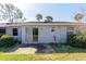 Backyard with grass and patio. Mature palm trees in view at 97 Lake Villa Way, Kissimmee, FL 34743