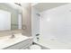 Bright bathroom features a single sink vanity and a tiled shower-over-tub at 97 Lake Villa Way, Kissimmee, FL 34743