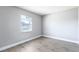 Bright bedroom with neutral paint, laminate flooring, and a window at 97 Lake Villa Way, Kissimmee, FL 34743