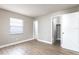 Bedroom with wood-look floors, a window, and an open closet at 97 Lake Villa Way, Kissimmee, FL 34743