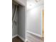 Hallway with wood-look floors leading to a closet and bathroom at 97 Lake Villa Way, Kissimmee, FL 34743