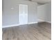 Bright living room features sleek, modern floors, neutral paint, and closet for storage at 97 Lake Villa Way, Kissimmee, FL 34743