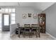 Dining area features wood flooring, a dining table with four chairs, and a vintage china cabinet at 1006 Gotwalt Dr, Oviedo, FL 32765