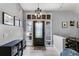 Bright foyer features wood flooring, a decorative light fixture, and sidelights around the front door at 1006 Gotwalt Dr, Oviedo, FL 32765