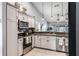 Well-lit kitchen with granite counters, stainless steel appliances, and ample cabinet space at 1006 Gotwalt Dr, Oviedo, FL 32765