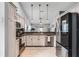 Spacious kitchen featuring stainless steel appliances, granite counters, and modern lighting at 1006 Gotwalt Dr, Oviedo, FL 32765