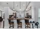 Eat-in kitchen with granite counters, bar stool seating, modern pendant lighting, and white cabinetry at 1006 Gotwalt Dr, Oviedo, FL 32765