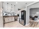 Bright kitchen features stainless steel appliances, granite countertops, and views into living room at 1006 Gotwalt Dr, Oviedo, FL 32765
