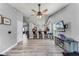 Open-concept living room flows into kitchen, featuring modern flooring, ceiling fan, and entertainment center at 1006 Gotwalt Dr, Oviedo, FL 32765