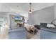 Open-concept living room with neutral walls, wood flooring, and comfortable furniture at 1006 Gotwalt Dr, Oviedo, FL 32765