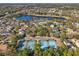 Aerial view showcasing the neighborhood's lake, tennis courts, and pool at 1098 Victoria Hills S Dr, Deland, FL 32724