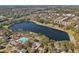 A drone shot showing a lake and community pool nestled within a lush, green landscape at 1098 Victoria Hills S Dr, Deland, FL 32724