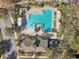 Aerial view of a large community pool with lounge chairs and mature landscaping at 1098 Victoria Hills S Dr, Deland, FL 32724
