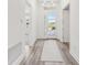Bright entryway featuring a long hallway with wood floors and natural light at 1098 Victoria Hills S Dr, Deland, FL 32724
