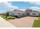 Charming single-story home featuring a two car garage, stone accents, and a brick paver driveway at 1098 Victoria Hills S Dr, Deland, FL 32724