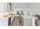 Bright kitchen features an island with seating, a wine fridge, and stainless appliances at 1098 Victoria Hills S Dr, Deland, FL 32724