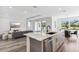 The kitchen and living room showcase an open-concept design with sleek finishes at 1098 Victoria Hills S Dr, Deland, FL 32724