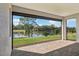 Covered lanai overlooking the lake and lush landscaping at 1098 Victoria Hills S Dr, Deland, FL 32724