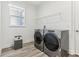 A well-lit laundry room with modern washer and dryer at 1098 Victoria Hills S Dr, Deland, FL 32724
