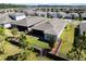 Aerial view of a backyard, neighboring houses, and serene pond at 1121 Avery Meadows Way, Deland, FL 32724