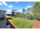 Lush backyard featuring green grass, mature trees, and a black metal fence providing privacy at 1121 Avery Meadows Way, Deland, FL 32724