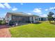 Expansive backyard with lush grass and a screened patio, ideal for outdoor relaxation and entertaining at 1121 Avery Meadows Way, Deland, FL 32724
