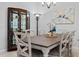 Dining area featuring a wood table, elegant decor, and an adjacent glass cabinet for storage at 1121 Avery Meadows Way, Deland, FL 32724