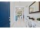 Inviting foyer boasts bright tile flooring, a modern mirror, and a view into the open living spaces at 1121 Avery Meadows Way, Deland, FL 32724