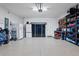 Well-organized garage with epoxy floors, overhead storage, shelving, refrigerator, and ample room for storage at 1121 Avery Meadows Way, Deland, FL 32724