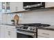 The kitchen features white cabinets, stainless steel appliances and granite countertops at 1121 Avery Meadows Way, Deland, FL 32724