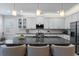 Contemporary kitchen showcasing granite countertops, a breakfast bar, white cabinetry, and stainless steel appliances at 1121 Avery Meadows Way, Deland, FL 32724