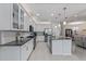 Bright kitchen with white cabinetry, stainless appliances, kitchen island and tile flooring at 1121 Avery Meadows Way, Deland, FL 32724