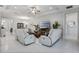 Bright and spacious living room with ample seating, a ceiling fan and stylish decor at 1121 Avery Meadows Way, Deland, FL 32724