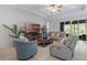 Cozy living room with comfortable seating, a ceiling fan and ample natural light at 1121 Avery Meadows Way, Deland, FL 32724